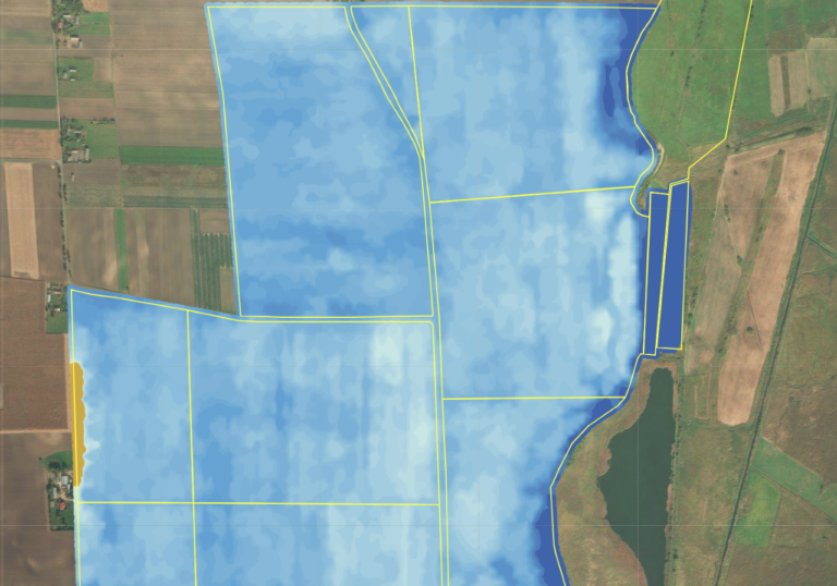 satellite map showing a patchwork of fields, areas of which are highlighted in blues of differing intensities