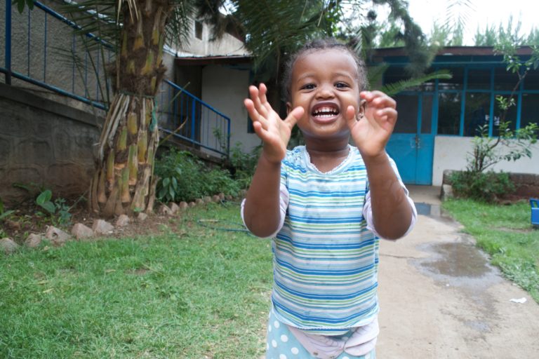 Girl running towards the camera and laughing