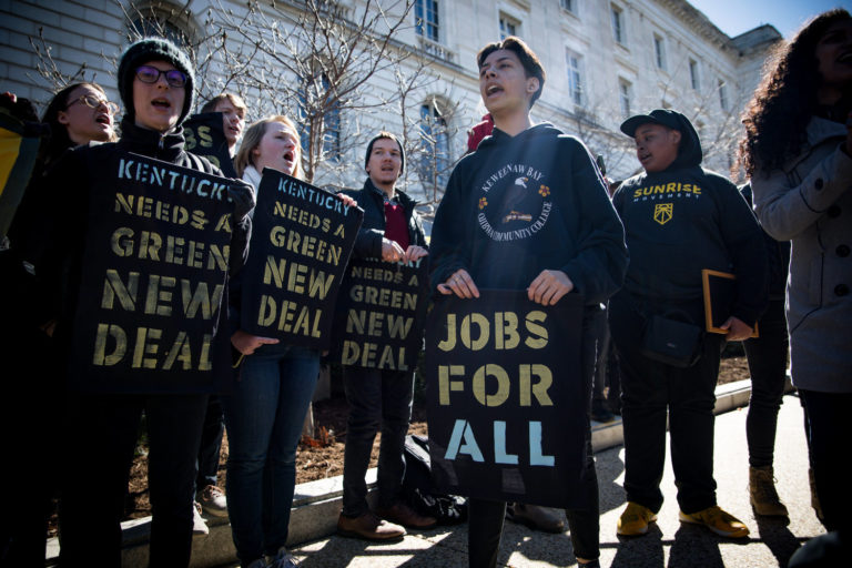 Protesters with placards with slogans including 'jobs for all', Kentucky needs a green new deal', 