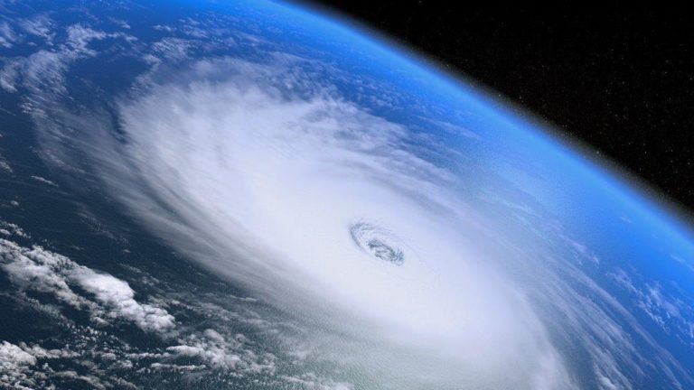 Photograph from space of a hurricane with swirling cloud and a clear eye