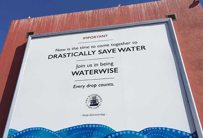 Billboard in Cape Town with the text "Now it is time to come together to drastically save water - Join us in being waterwise - Every drop counts"