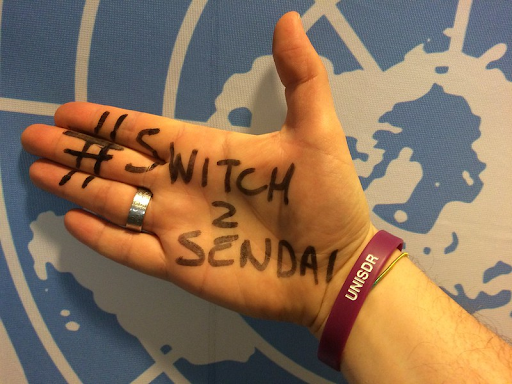 Photograph of hand with the text “#Switch 2 Sendai” written on it