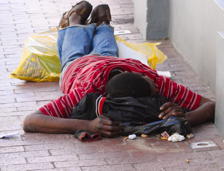 A boy laying down in the street