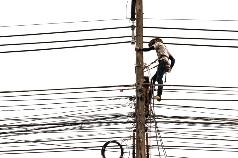 Worker in power tower (electricity pylon)