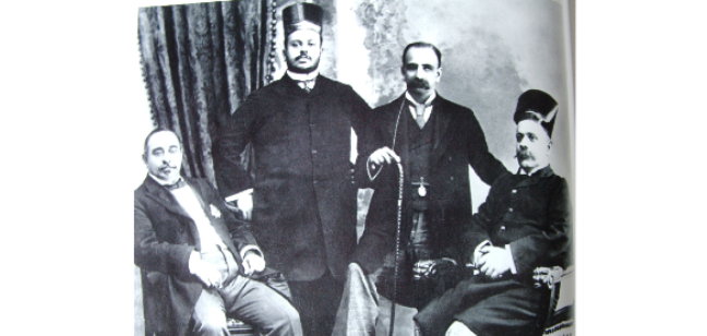 Black and white photograph of four smartly dressed Parsi industrialists