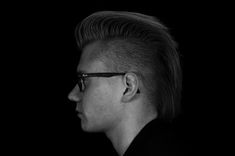 Man with mohawk in dark background