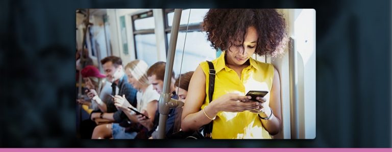 A woman watching/consuming media on her phone whilst on public transport