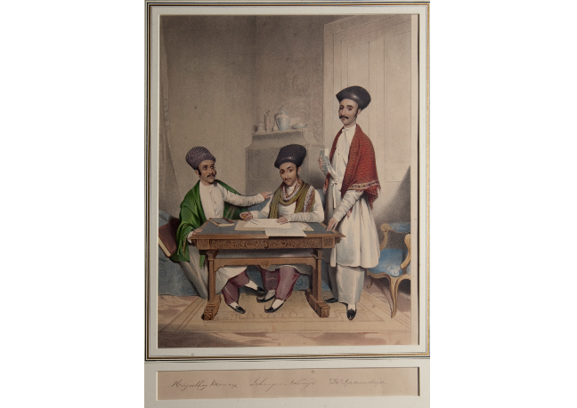 Hirjeebhoy Merwanjee Wadia (1817–83), Jehangeer Nowrojee Wadia (1821–66) and Dorabjee Muncherjee Nanjivohra Painting of three men. Two are sat at a table with papers and the third is stood next to them.