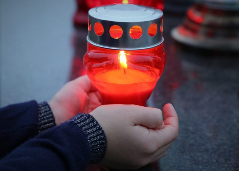 Image for decorative purposes. Candle being held in someone's hands.