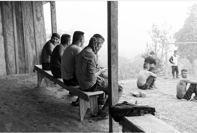 Members of FARC watch a game of football