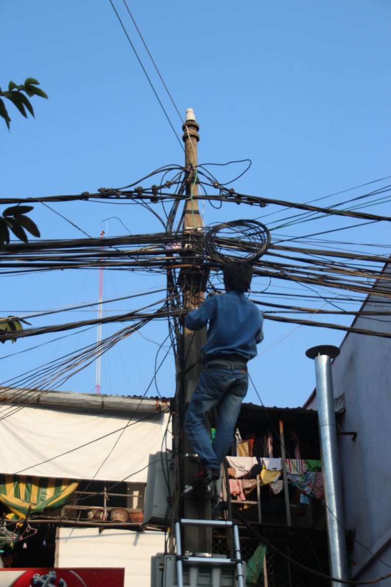 A worker working close to high-current lines being exposed to several risk