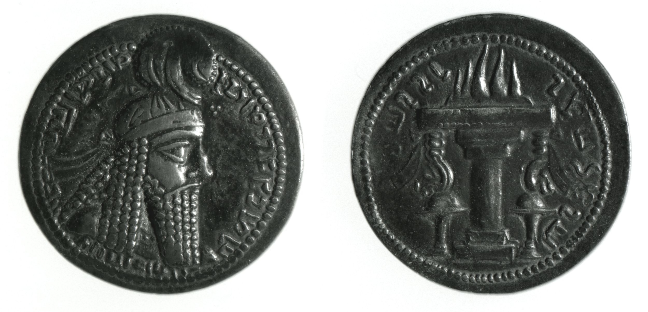 Two sides of a coin. One side shows a man's face in profile with a cap and long beared. The other side shows a fire table.