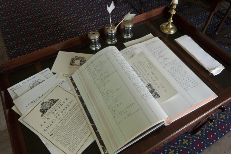 An open ledger on top of menus for the royal family at a desk in Kew Palace
