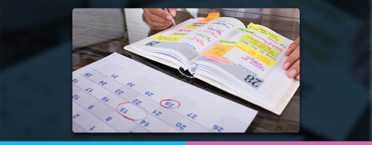 An image of a desk calendar and diary planner on a table