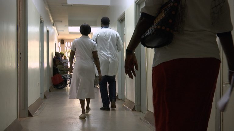 hospital staff walking down a corridor at a hospital