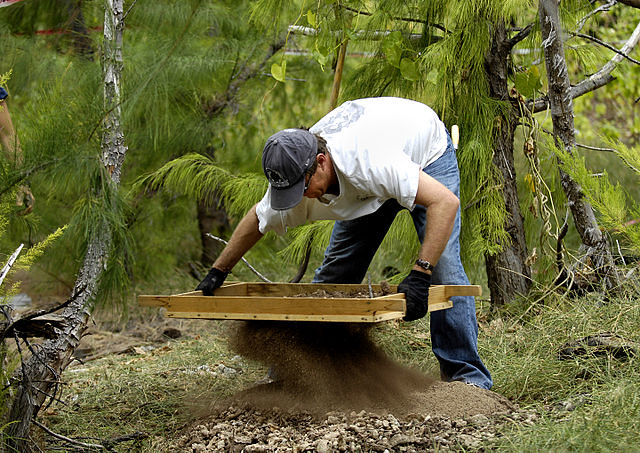 Soil from a grave been sieved through a fine mesh to recover any particles or trace evidence