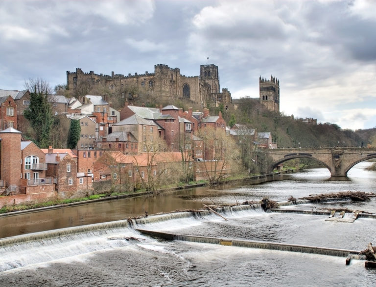 A view of Durham cathedral and castle and part of the city with the River Weir in the foreground