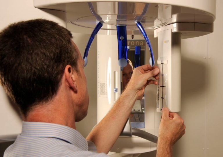 photo of person working on x-ray equipment