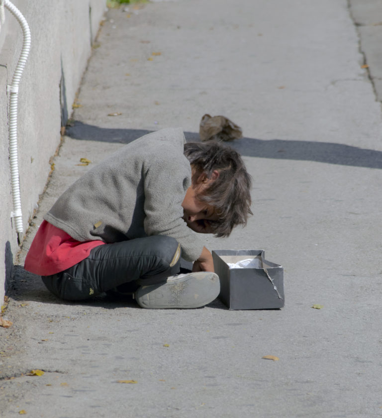 Child sitting in the street, begging_COLOURBOX5371111.jpg