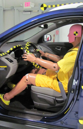 a crush dummy sitting behind the wheel of a car