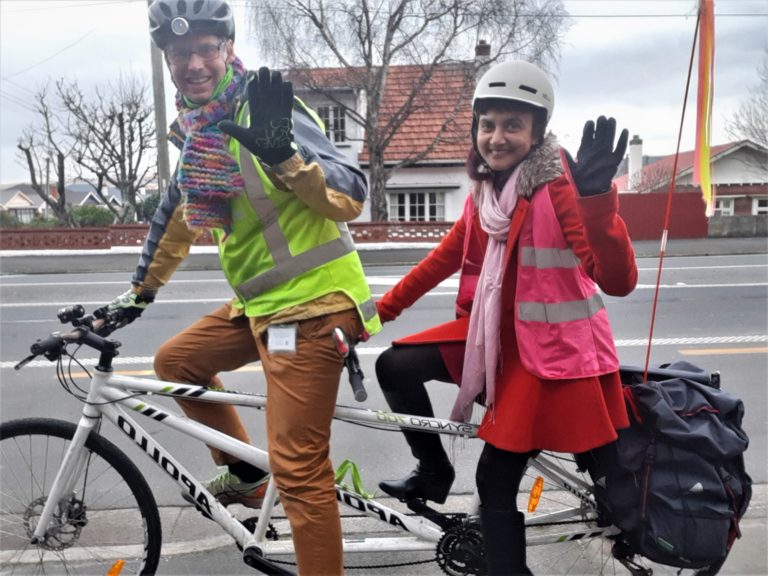 Dr Michael Pryde riding a double bicycle with a woman