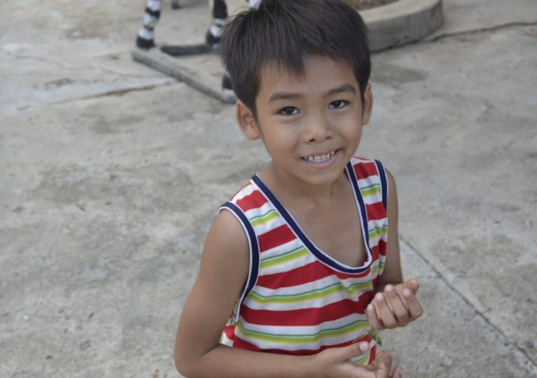 A boy is smiling at the camera.