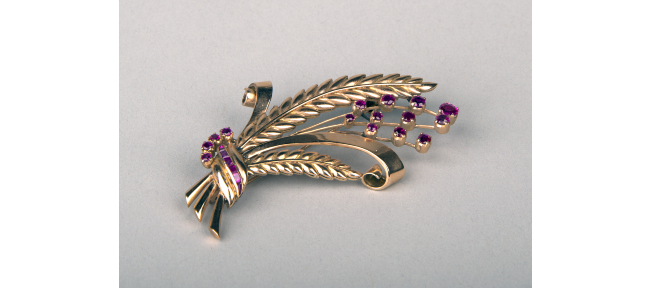Small golden brooch in the shape of a grass bouquet, set with purple rubies