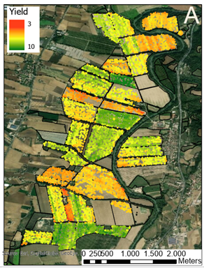 aerial photograph of a patchwork of fields, some of which are highlighted in red, yellow and green