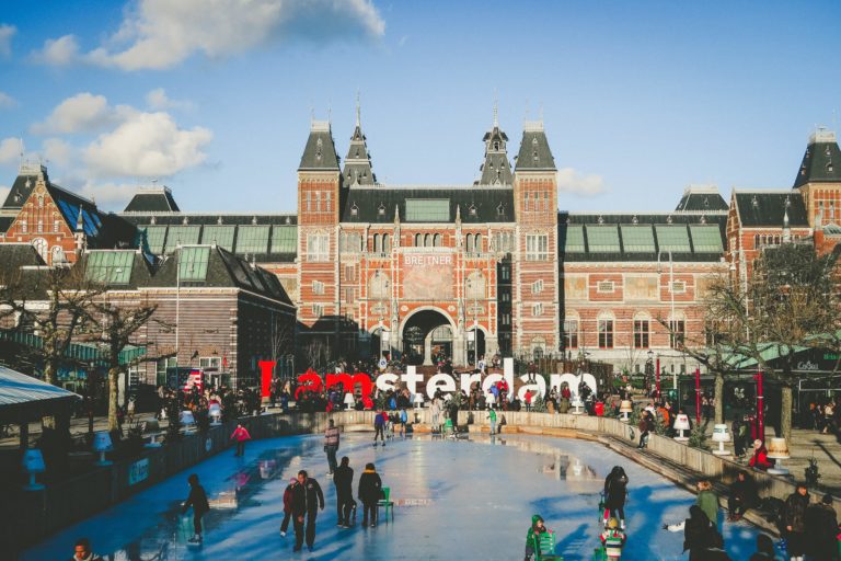 Large crowd walking and ice skating in front of the Rijksmuseum in Amsterdam