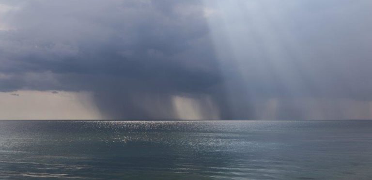 Photograph of a shower in the distance out to sea