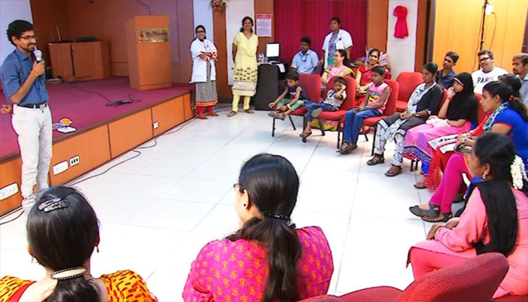 Patient talking to a group of other patients at the clinic