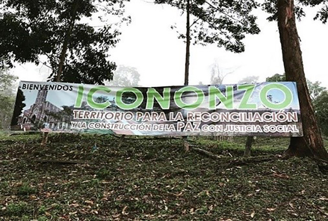 The entrance to the FARC-EP demobilisation camp near Icononzo, Colombia. The sign reads: "Territory for reconciliation through the constructions of peace with social justice". © Chiara Mizzoni"