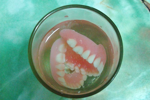 image of dentures soaking in water