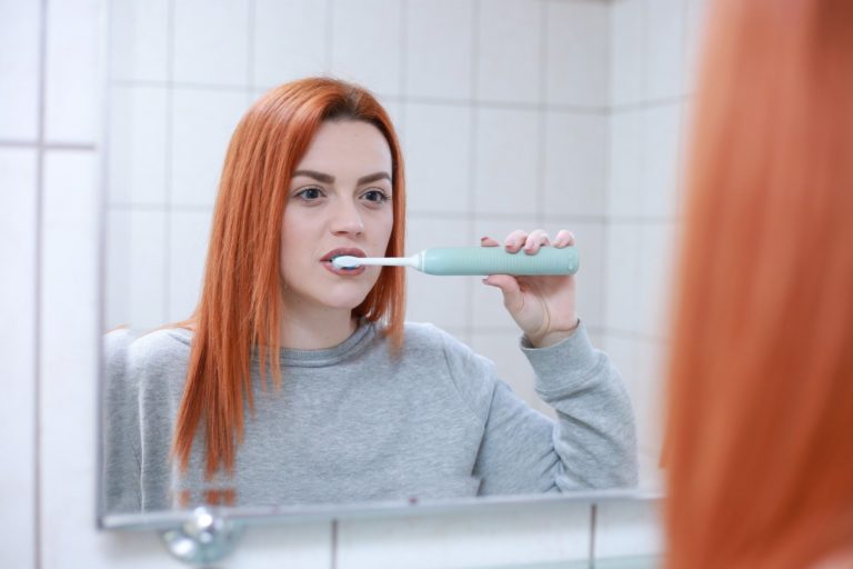 Photo of a teenager brushing their teeth