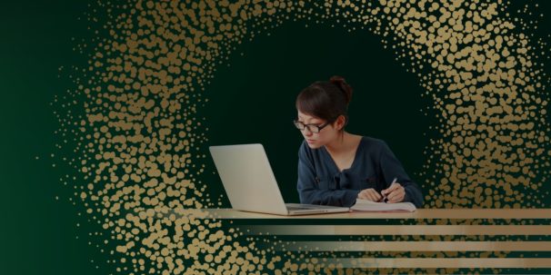 student with laptop studying with gold and green background