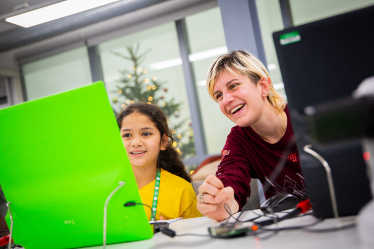 A photograph of an educator and learner at a Code Club