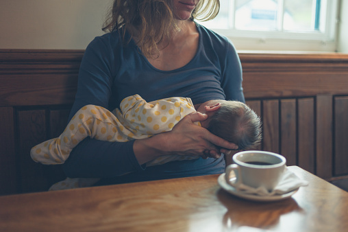 image of mother breastfeeding in cafe
