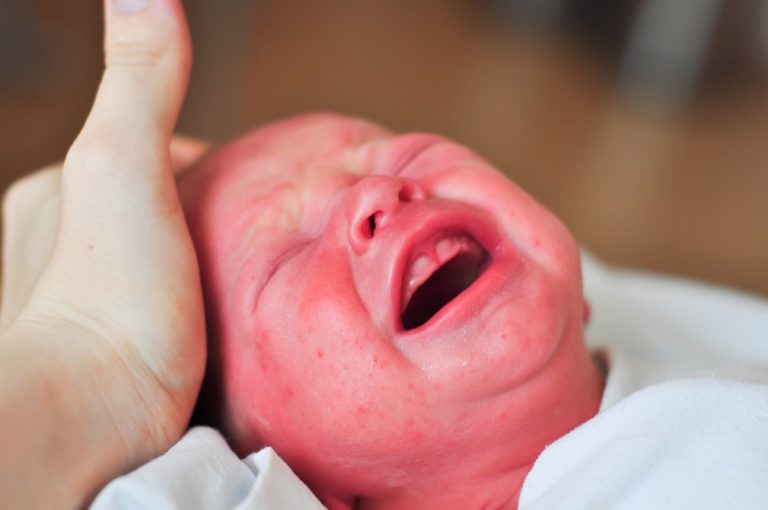 A close up of a newborn baby’s open mouth, gums and jaw.