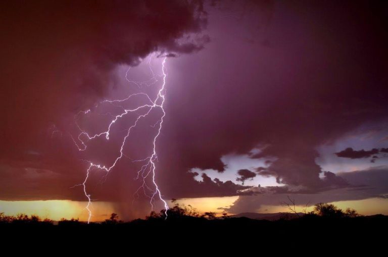 Photograph of a lightning strike just after sunset