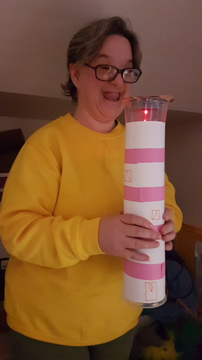 A woman shows the candle she has made