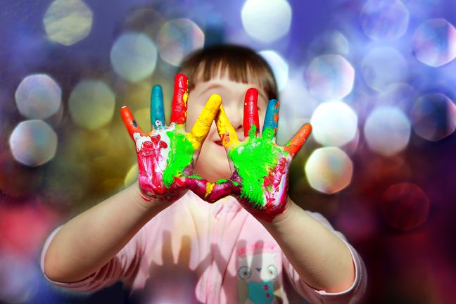 Cute little kid with painted hands.