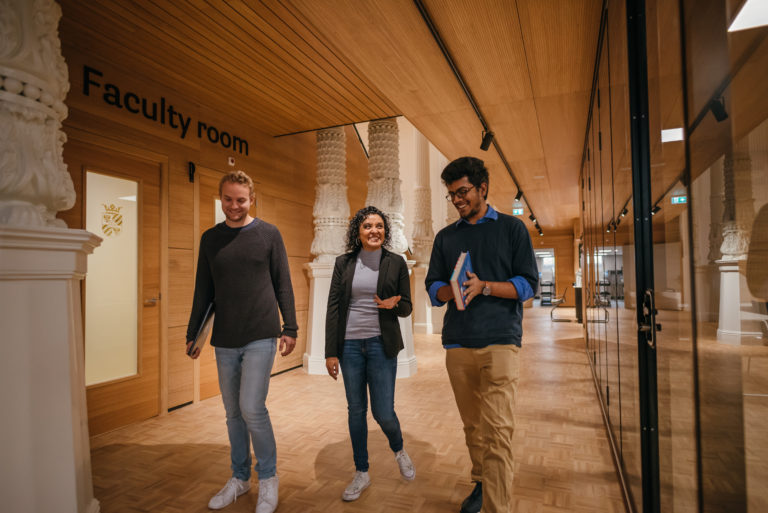 Three students walking the halls of Campus Fryslân
