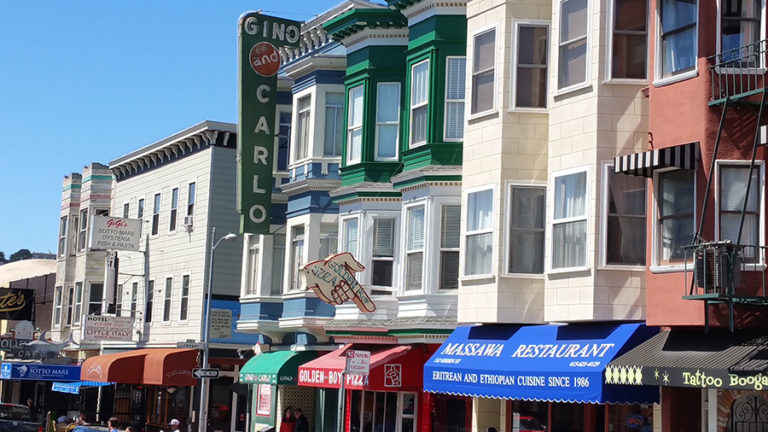 Image of a street in San Francisco with a variety of signs
