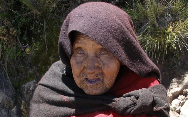 Blind woman spinning wool by hand in Taquile, Peru