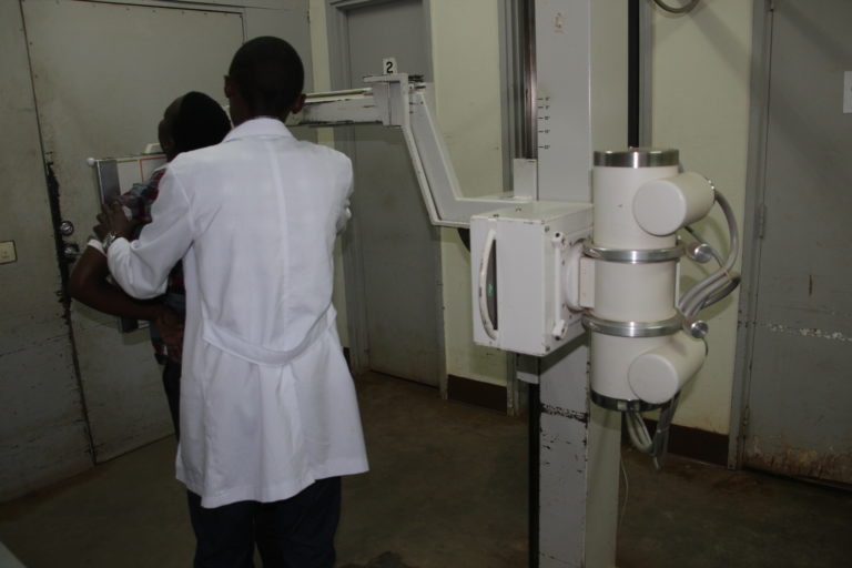 A doctor prepairing to take an x-ray of a patient
