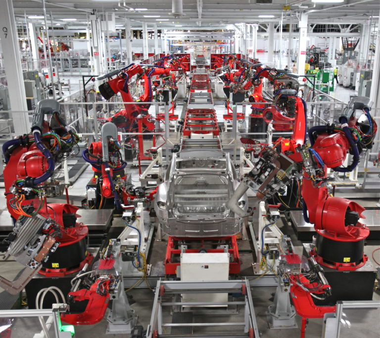 An automated production line in a car factory incorporating robot manipulators.