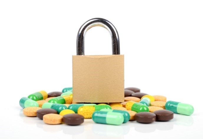 picture of a padlock on top of a pile of pills