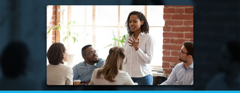 Woman in a meeting presenting to colleagues