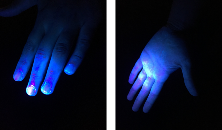 Photo of hands and hands with UV light shining on them