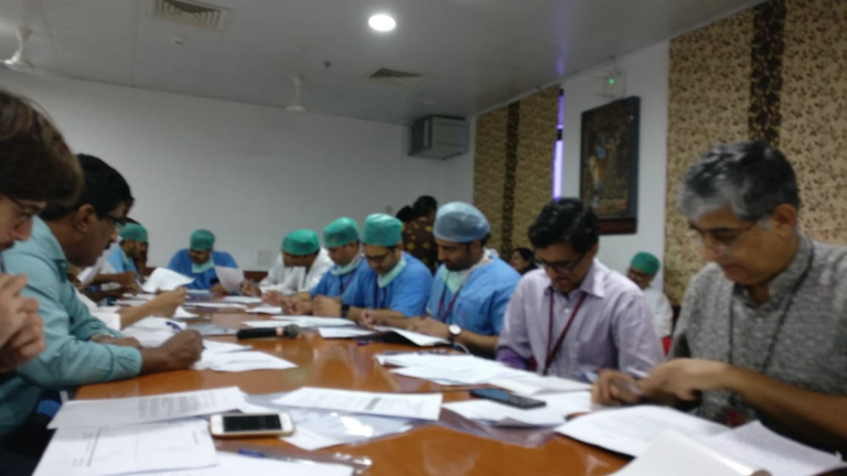 Image of medical professionals around a table